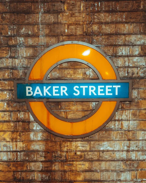 Baker Street sign attached to a rustic brick wall