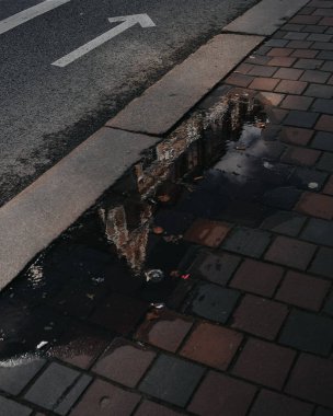 Yağmurdan sonra sokaktaki su birikintisinin dikey görüntüsü.
