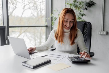 A financial advisor calculating and working in an office