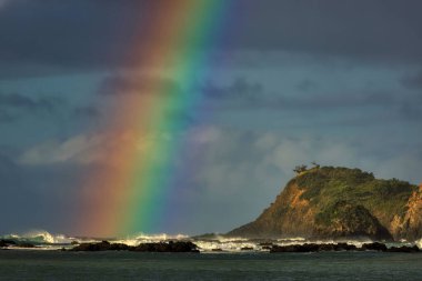Rough sea and Rainbow of the coast of Bland Bay, Northland, New Zealand