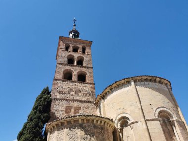 A low-angle shot of the historic Church of San Andres in Segovia against a blue sky