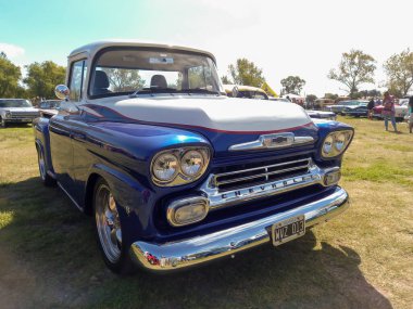 Old blue utility Chevrolet Chevy Apache V8 pickup truck 1958 by GM in the countryside. Front view. Nature grass trees. Classic car show. Copyspace