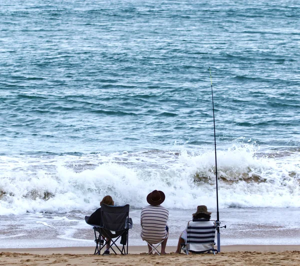 A closeup shot of people doing fishing in the sea on a sunny day