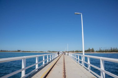 A beautiful view of a dock by the sea on a blue sky background