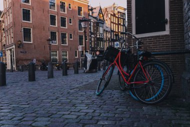 A couple of bicycles leaned on an old brick building in the city of Amsterdam, Netherlands