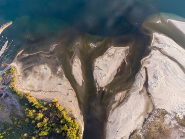 An aerial view of a seashore under the sunlight