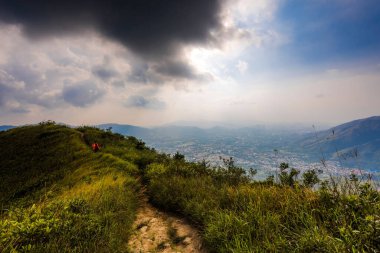 View of a natural landscape with mountains and plants under cloudy sky