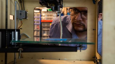 A Latino man working in a workshop