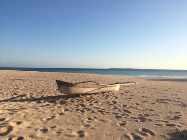 An old wooden boat on a sandy beach in East Nusa Tenggara, Indonesia