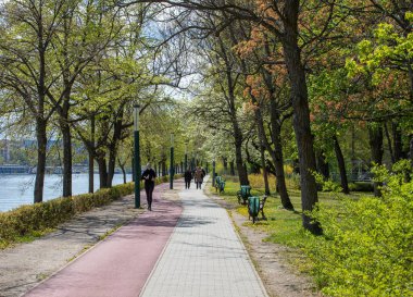 The people walking in the park on a sunny day in Budapest, Hungary