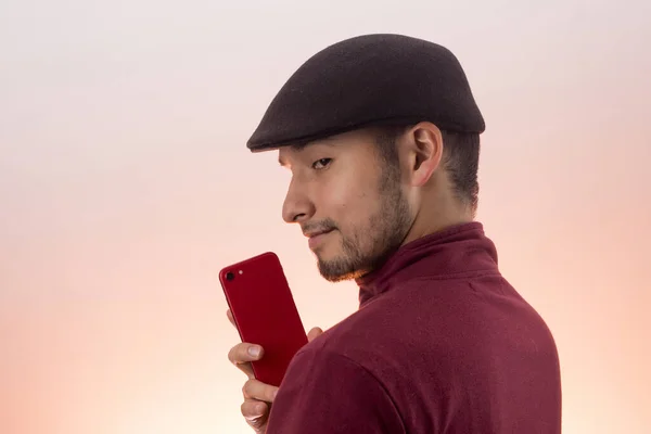 Latin Young Male Hat Using His Red Cell Phone — Foto de Stock