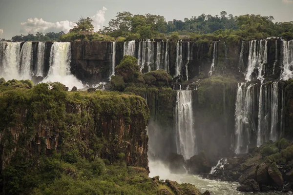 A beautiful landscape of a waterfall on a cloudy day