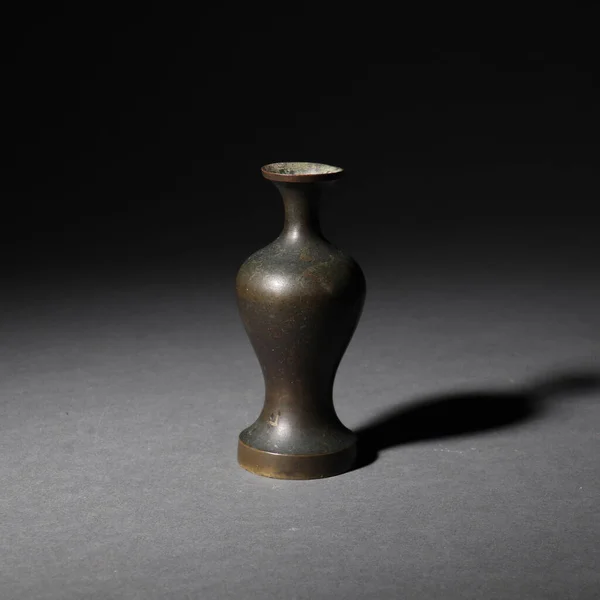 A closeup of an old jar in China isolated on a dark background