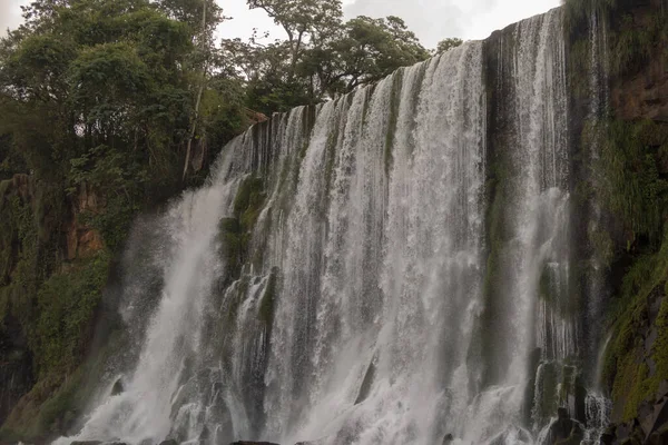 A beautiful landscape of a waterfall on a cloudy day