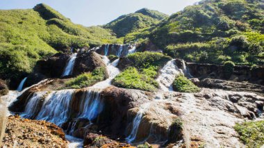 A small creek on the mossy rocks