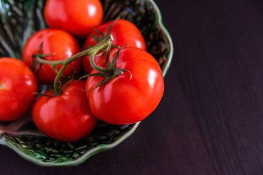 Fresh healthy organic picked tomatoes in a bowl on a table