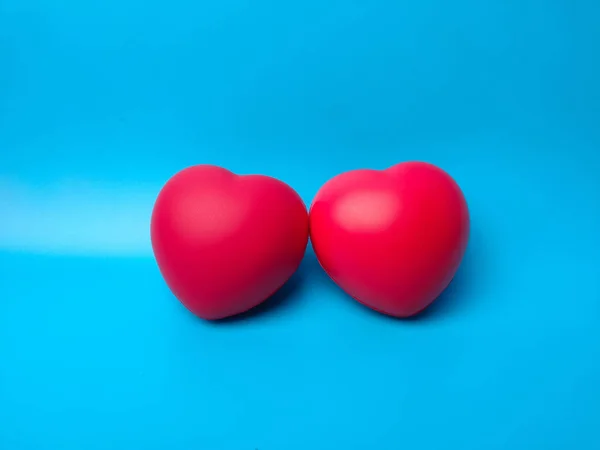 Closeup Two Cute Red Hearts Placed Together Vibrant Blue Background — Stock Photo, Image