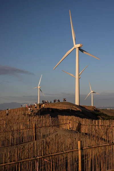 A vertical shot of a row of wind turbines on Caota dune beach in Taiwan