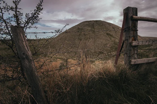 Small Mountain Surrounded Thorny Fence Cloudy Day Rural Area — Stock Photo, Image