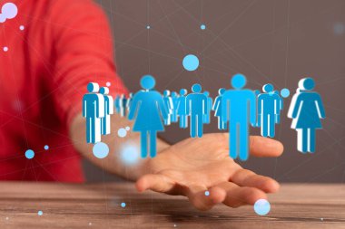 Cinsiyet profili simgelerinden oluşan birbirine bağlı bir ağın dijital görüntüsünü elinde tutan bir işadamı