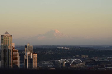 Washington, ABD 'de günbatımında arka planda Rainier Dağı' nın olduğu Seattle 'ın hava görüntüsü.