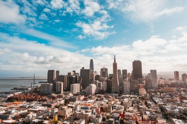 A cityscape with a cloudy sky of the Transamerica Pyramid Skyscraper in San Francisco, California, USA