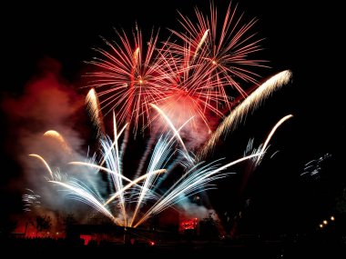 Gece gökyüzündeki parlak renkli havai fişekler.