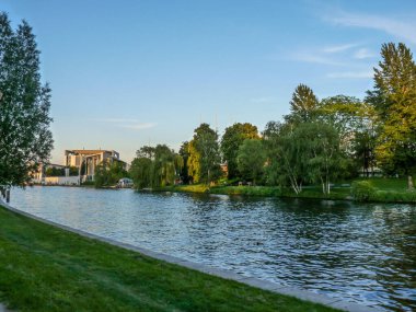 A scenic view of a lake in a park in Berlin, Germany in blue sky background