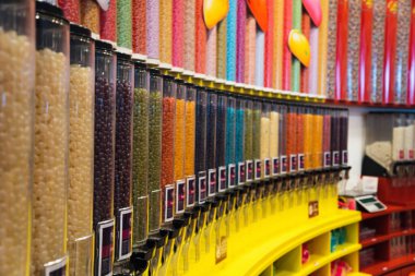 A rack with jars of colorful candy in the store