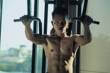 A sweaty man working out in the gym.