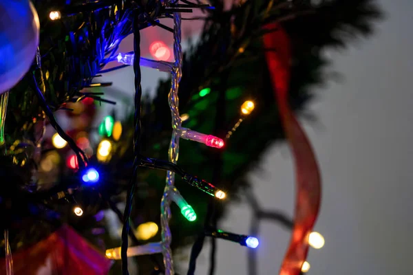 A closeup shot of colorful lights on a Christmas tree