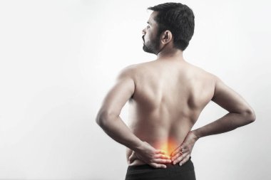 man suffering from lower spine pain with red highlight on lumbar spine in white background