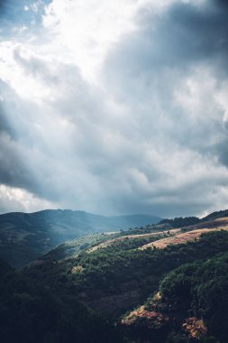 A scenic view of the mountains against the sky with sunshine
