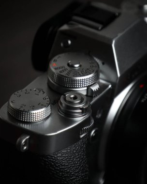 A closeup shot of the mode and main command dial of the camera isolated on a black background