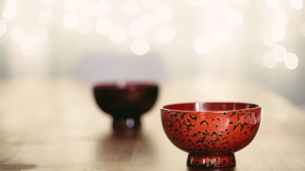 A beautiful red handmade Urushi dish. Japanese lacquered tableware on a blurry background
