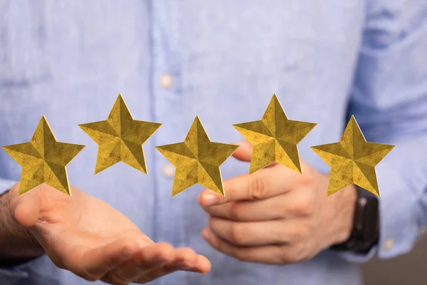 A 3d rendering of a review icon and rating stars showing a feedback levitating above a person\'s hands