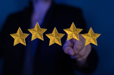 A man pointing at 3D rendering of five stars in a foreground. A concept of ranking for excellence
