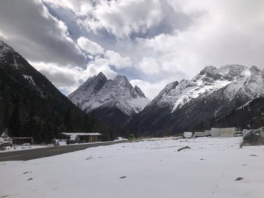 A beautiful shot of some mountains partly covered in snow.