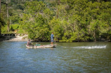 A beautiful shot of a fisherman on a boat while fishing