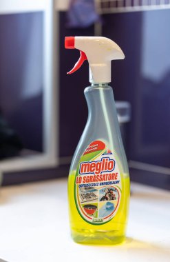 A vertical closeup of a Meglio brand fat removing and cleaning liquid in a spray bottle