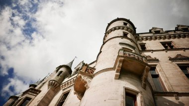 A low angle shot of the Dunrobin Castle & Gardens, Stately home in Scotland with cloudy sky