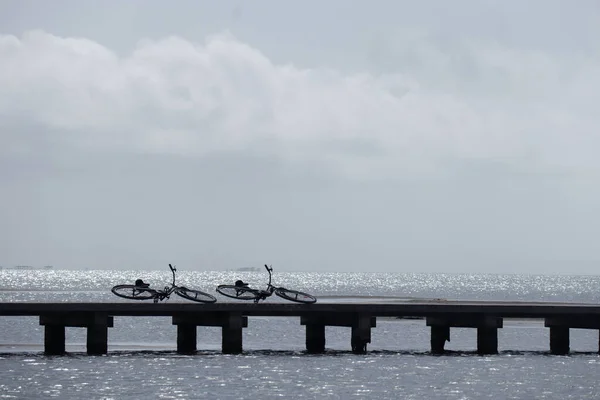 Two Bicycles Lying Beach Pier Sepia Style Quiet Scene — Stockfoto