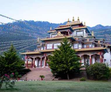 Arkasında dağlar olan bir Budist tapınağının güzel dış görünüşü.