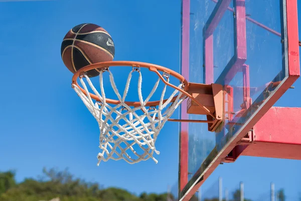 basketball ball on an outdoor basketball court, after basketball player shot