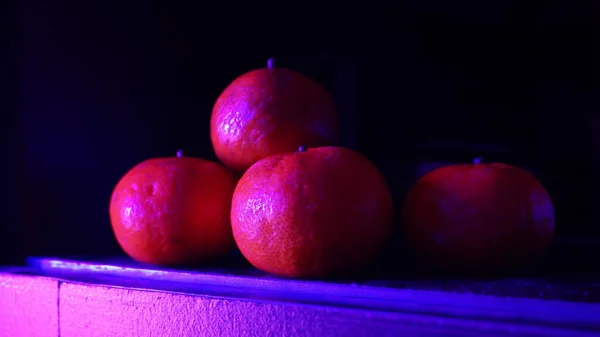Closeup Pile Ripe Delicious Clementine Neon Purple Lights Shining Them — Stock Photo, Image