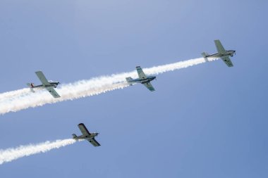 A low angle shot of an aircraft display in a blue sky over Malaga, Spain