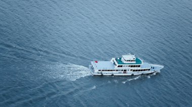 A closeup shot of a white boat sailing on the sea