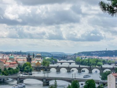 A scenic view of old bridges in Prague, the Czech Republic in cloudy sky background