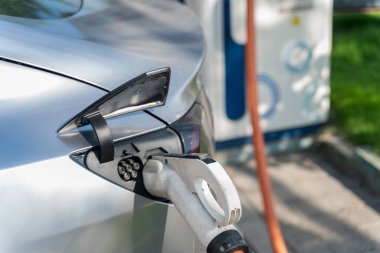 A closeup shot of an electric vehicle charging at the station