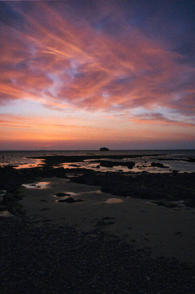 A beautiful view of a beach during low tide at sunset in Isle of Wight